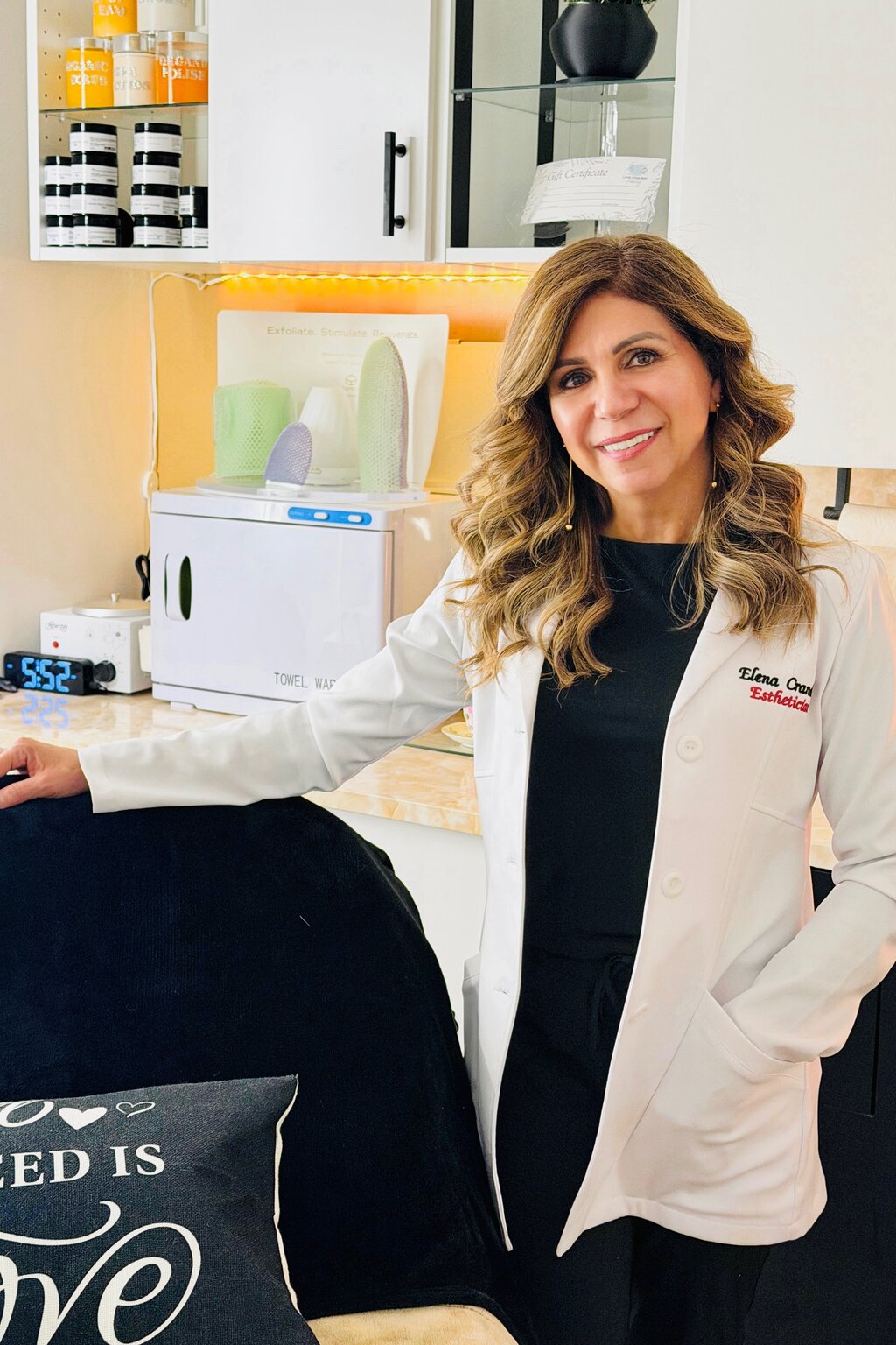 Elena Crandell, esthetician, in a white lab coat at the Love Your Skin Beauty suite